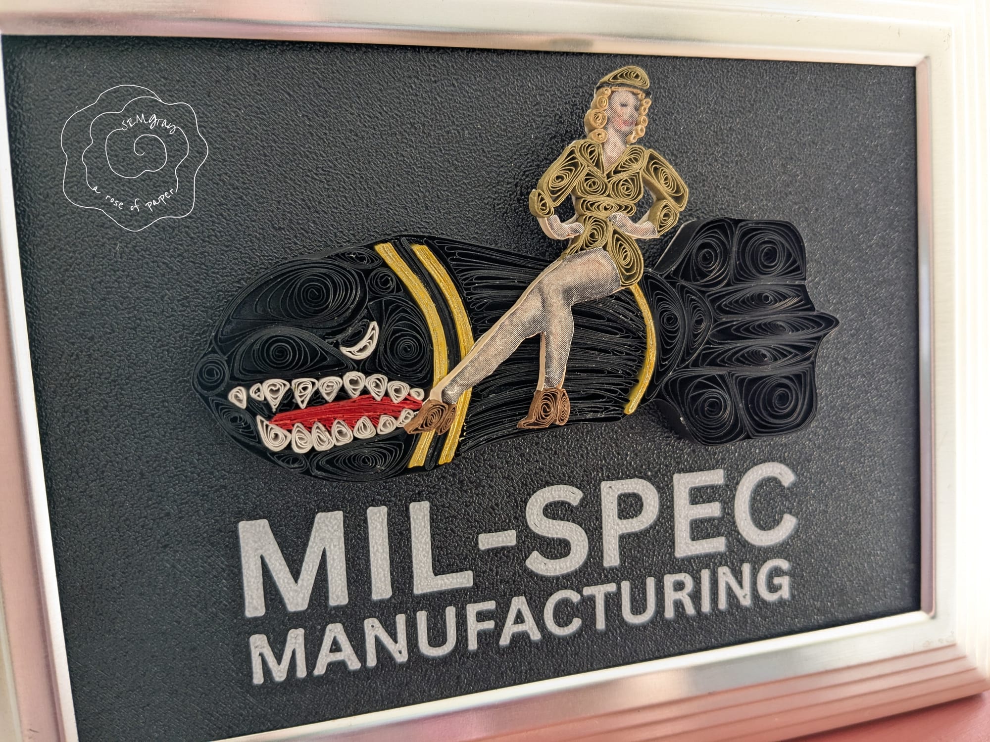 MilSpec Manufacturing logo as hand-quilled paper art